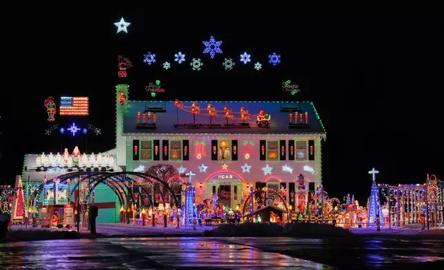 FILE - A home is decked out in holiday lights and Christmas decorations in Strongsville, Ohio, Dec. 2, 2025. (AP Photo/Sue Ogrocki, File)