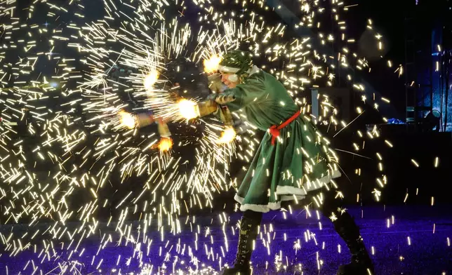 FILE - A performer attends a light show at Ala-Too Square decorated for the New Year and Christmas festivities in Bishkek, Kyrgyzstan, Dec. 15, 2025. (AP Photo/Vladimir Voronin, File)