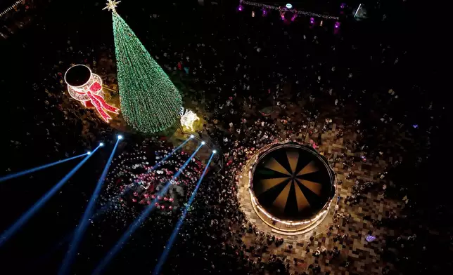 FILE - People gather for a concert during a tree lighting event at Skanderbeg Square in Tirana, Albania, Dec. 6, 2025. (AP Photo/Hameraldi Agolli, File)