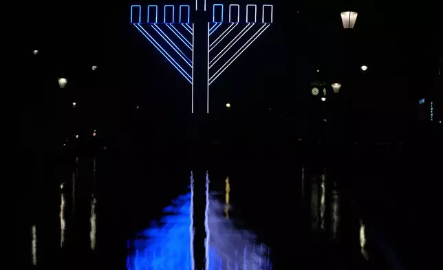 FILE - A menorah is lit to celebrate Hanukkah in Trafalgar Square, London, Dec. 16, 2025. (AP Photo/Kin Cheung, File)