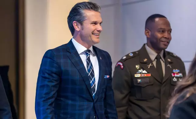 Defense Secretary Pete Hegseth smiles as he walks to a secure room in the basement of the Capitol to brief lawmakers on how he handled a military strike on a suspected drug smuggling boat and its crew in the Caribbean near Venezuela Sept. 2, at the Capitol in Washington, Tuesday, Dec. 9, 2025. (AP Photo/J. Scott Applewhite)