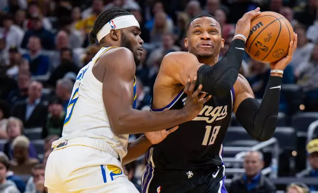 Sacramento Kings guard Russell Westbrook (18) reacts after making contact with the defense of Indiana Pacers forward Jarace Walker en route to the basket during the first half of an NBA basketball game in Indianapolis, Monday, Dec. 8, 2025. (AP Photo/Doug McSchooler)