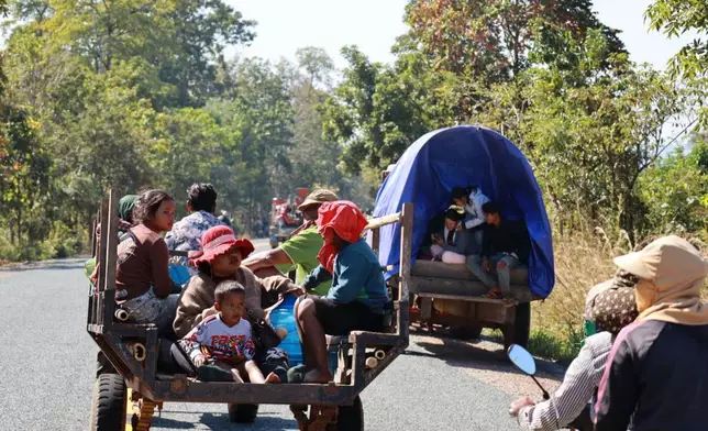In this photo released by Agence Kampuchea Press (AKP), Cambodian villagers, transported by motor cart and tractor, flee from their home in Preah Vihear province, Cambodia, Monday, Dec. 8, 2025. (AKP via AP)