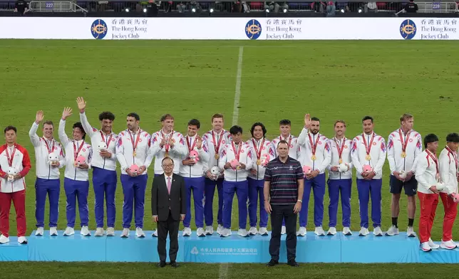 Hong Kong Jockey Club Chairman The Hon Martin Liao (front row, left) presents gold medals to the Hong Kong team, winers of The Hong Kong Jockey Club Trophy Rugby Sevens Competition at the 15th National Games.
