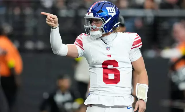 New York Giants quarterback Jaxson Dart celebrates his touchdown during the first half of an NFL football game against the Las Vegas Raiders Sunday, Dec. 28, 2025, in Las Vegas. (AP Photo/John Locher)