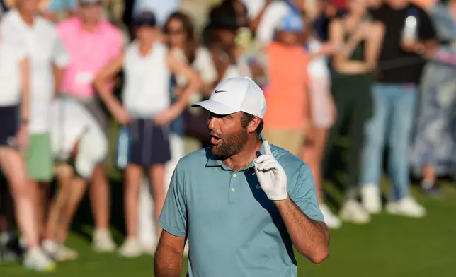 Scottie Scheffler, of the United States, reacts after his shot on 18th green during the third round of the Hero World Challenge PGA Tour at Albany Golf Club in New Providence, Bahamas, Saturday, Dec. 6, 2025. (AP Photo/Fernando Llano)
