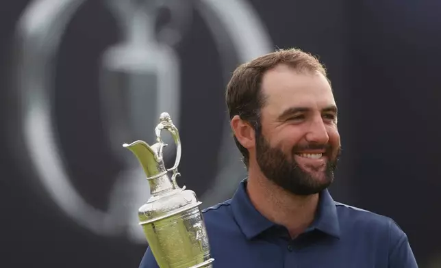 FILE - Scottie Scheffler of the United States holds the Claret Jug trophy as he poses for photographers after winning the British Open golf championship at the Royal Portrush Golf Club, Northern Ireland, July 20, 2025. (AP Photo/Peter Morrison, File)