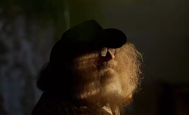Henry County Local correspondent Joe Durbin pauses in the late day sun as he interviews participants during the Beef Bash 2025 tasting event at the Berry Center, Saturday, Oct. 11, 2025, in New Castle, Ky. (AP Photo/Carolyn Kaster)