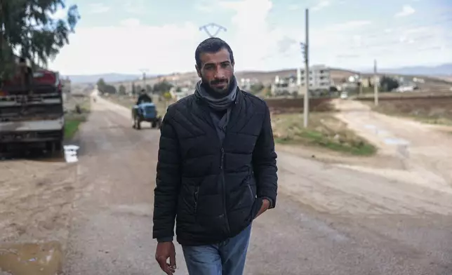 Former detainee Mohammad Marwan walks down a street on his way to the Homs Recovery Center in the village of Tell Dahab in the Homs countryside, Syria, Tuesday, Dec. 2, 2025. (AP Photo/Ghaith Alsayed)