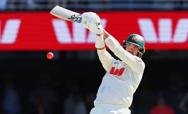 Australia's Mitchell Starc plays a shot during the second Ashes cricket test match between Australia and England in Brisbane, Saturday, Dec. 6, 2025.. (AP Photo/Tertius Pickard)