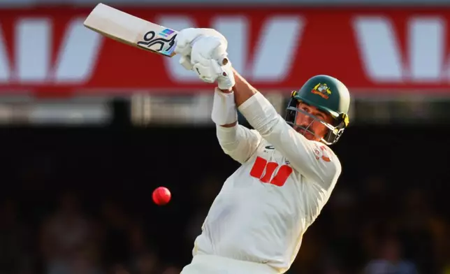 Australia's Mitchell Starc plays a shot during the second Ashes cricket test match between Australia and England in Brisbane, Saturday, Dec. 6, 2025.. (AP Photo/Tertius Pickard)