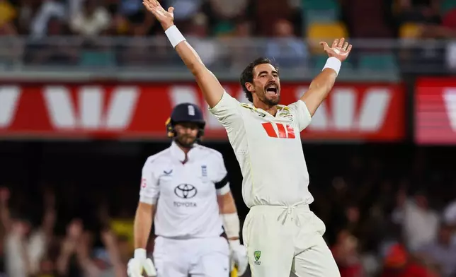 Australia's Mitchell Starc appeals successfully for the wicket of England's Joe Root, left, during the second Ashes cricket test match between Australia and England in Brisbane, Saturday, Dec. 6, 2025.. (AP Photo/Tertius Pickard)
