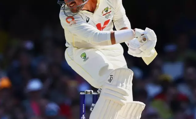 Australia's Mitchell Starc keeps away from bouncer a delivery during the second Ashes cricket test match between Australia and England in Brisbane, Saturday, Dec. 6, 2025.. (AP Photo/Tertius Pickard)