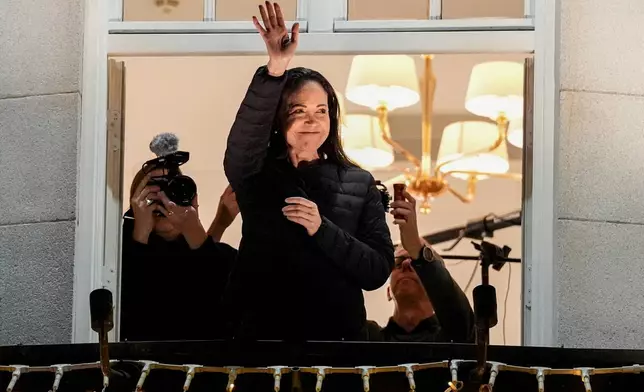 Nobel Peace Prize laureate Maria Corina Machado waves at the Grand Hotel in Oslo, Norway, early Thursday, Dec. 11, 2025. (Lise Åserud/NTB Scanpix via AP)