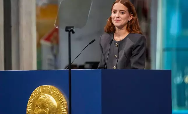 The daughter of the Nobel Peace Prize laureate, Ana Corina Sosa, accepts the award on behalf of her mother, Venezuelan opposition leader Maria Corina Machado, during the Nobel Peace Prize ceremony at Oslo City Hall, Norway, Wednesday Dec. 10, 2025. (Ole Berg-Rusten/NTB Scanpix, Pool via AP)