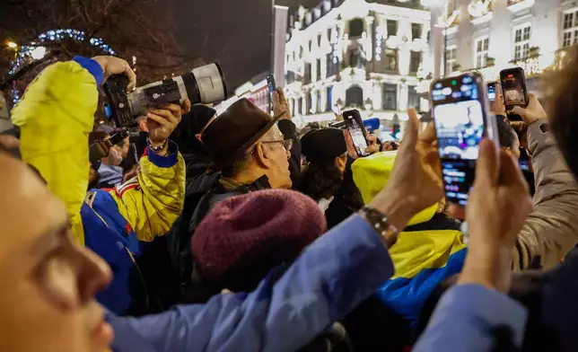 People wait to see Nobel Peace Prize laureate Maria Corina Machado outside the Grand Hotel, in Oslo, Norway, early Thursday, Dec. 11, 2025. (Jonas Been Henriksen/NTB Scanpix via AP)