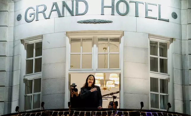 Nobel Peace Prize laureate Maria Corina Machado reacts to the crowd gathered below from a balcony at the Grand Hotel, in Oslo, Norway, early Thursday, Dec. 11, 2025. (Jonas Been Henriksen/NTB Scanpix via AP)