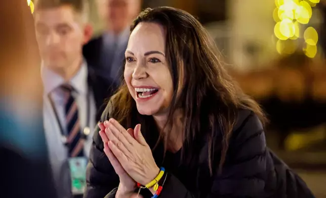 Nobel Peace Prize laureate Maria Corina Machado reacts to the crowd gathered in front of the Grand Hotel, in Oslo, Norway, early Thursday, Dec. 11, 2025. (Jonas Been Henriksen/NTB Scanpix via AP)