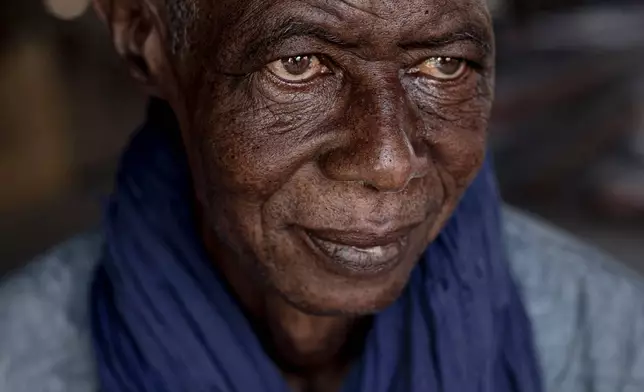 Peul herder Alioune Sow, a 61-year-old from Ndila, a village in the Louga region, keeps an eye on the sheep he brought to sell at the big livestock market in Dakar, Senegal, Oct. 26, 2025. Peul herders have traditionally raised animals across lands from Senegal to Nigeria. (AP Photo/Andrea Ferro)