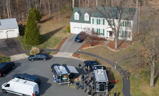 Prince William County Police block the street near the house where the FBI made an arrest, in Woodbridge, Va., Thursday, Dec. 4, 2025. (AP Photo/Steve Helber)