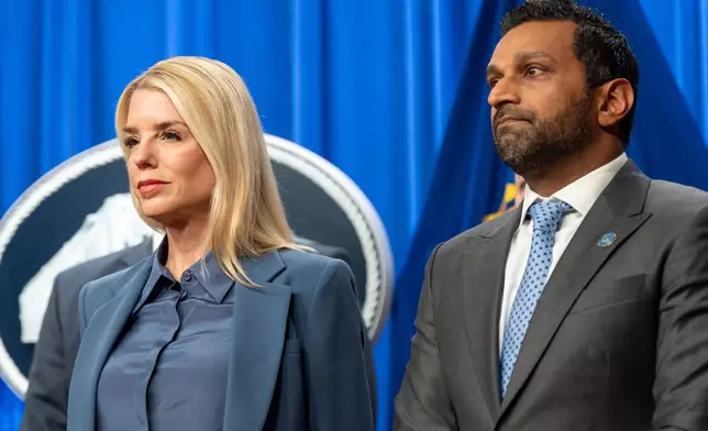Attorney General Pam Bondi, left, and FBI Director Kash Patel stand during a news conference at the Department of Justice, Thursday, Dec. 4, 2025, in Washington. (AP Photo/Alex Brandon)
