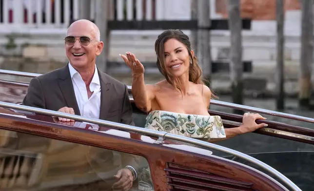 Jeff Bezos and Lauren Sanchez leave a hotel for their pre-wedding reception in Venice, Italy, June 26, 2025. (AP Photo/Luca Bruno, File)