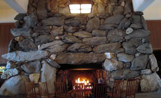 FILE - This Feb. 2, 2015 photo shows rocking chairs in front of the massive stone fireplace in the lobby of the Grove Park Inn in Asheville, N.C. (AP Photo/Beth J. Harpaz, File)