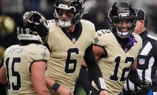 New Orleans Saints wide receiver Chris Olave, right, celebrates with quarterback Tyler Shough (6) and wide receiver Mason Tipton (15) after scoring a touchdown during the second half of an NFL football game against the New York Jets, Sunday, Dec. 21, 2025, in New Orleans. (AP Photo/Gerald Herbert)