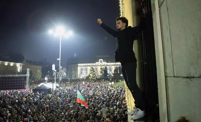 Protester raise his fist as as a swelling crowd of tens of thousands of Bulgarians filled Sofia's central square, demanding the government's resignation amid rising anger over corruption and contested economic policies, Sofia, Bulgaria, Wednesday, Dec. 10, 2025. (AP Photo/Valentina Petrova)