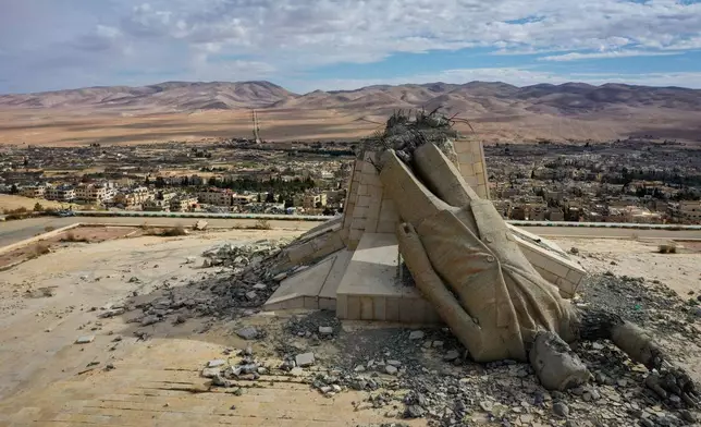 A statue of the late Syrian President Hafez Assad, which was toppled and defaced during the overthrow of the Assad regime, lies in ruins atop a mountain in Dayr Atiyah, Syria, Jan. 5, 2025. (AP Photo/Ghaith Alsayed, File)