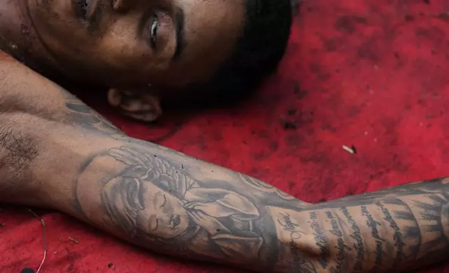 The body of a man killed during a police raid targeting the Comando Vermelho gang, lies in the Complexo da Penha favela of Rio de Janeiro, Brazil, Oct. 29, 2025. (AP Photo/Silvia Izquierdo, File)