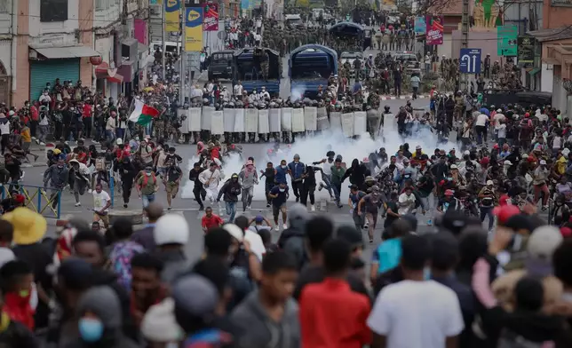 Demonstrators confront riot police during a protest against chronic cuts to electricity and water in Antananarivo, Madagascar, on Sept. 30, 2025. (AP Photo/Mamyrael, File)