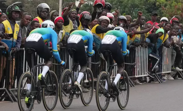 Rwanda's Eric Nkundabera, right, leads teammates Patrick Byukusenge and Mike Uwiduhaye during the team time trial mixed relay event at the road cycling World Championships in Kigali, Rwanda on Sept. 24, 2025. (AP Photo/Jerome Delay, File)
