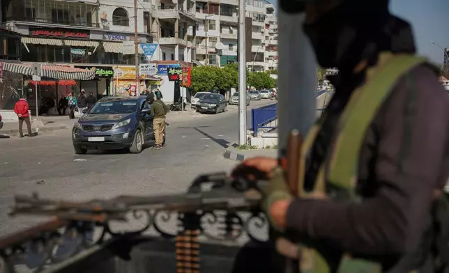 FILE- Syrian security forces inspect vehicles at a checkpoint, following a recent wave of violence between Syrian security forces and gunmen loyal to former President Bashar Assad, as well as subsequent sectarian attacks, in Latakia, in Syria's coastal region, March 11, 2025. (AP Photo/Ghaith Alsayed, File)