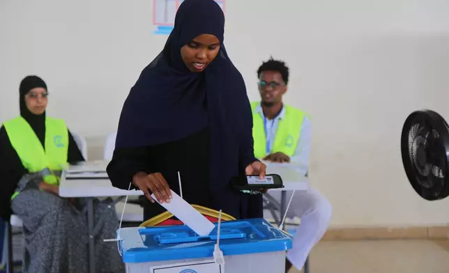 A woman casts her vote during the local election in Mogadishu, Somalia, Thursday, Dec. 25, 2025. (AP Photo/Farah Abdi Warsameh)
