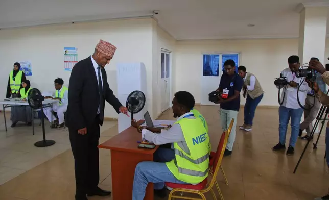 Somalia's former deputy prime minister Mahdi Mohamed Guled casts his vote during the local election in Mogadishu, Somalia, Thursday, Dec. 25, 2025. (AP Photo/Farah Abdi Warsameh)