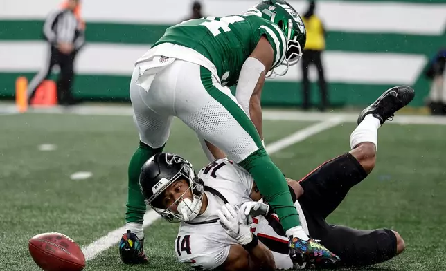 Atlanta Falcons wide receiver Jamal Agnew (14) fumbles the ball against the New York Jets during the first half of an NFL football game, Sunday, Nov. 30, 2025, in East Rutherford, N.J. (AP Photo/Adam Hunger)