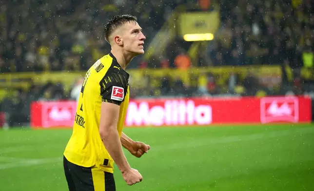 Borussia's Nico Schlotterbeck celebrates after scoring his side's second goal during Germany Bundesliga soccer match between Borussia Dortmund and TSG 1899 Hoffenheim, in Dortmund, Germany, Sunday, Dec. 7, 2025. (Bernd Thissen/dpa via AP)