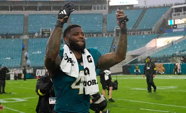 Jacksonville Jaguars defensive end Josh Hines-Allen (41) celebrates as he leaves the field following an NFL football game against the Indianapolis Colts, Sunday, Dec. 7, 2025, in Jacksonville, Fla. (AP Photo/John Raoux)