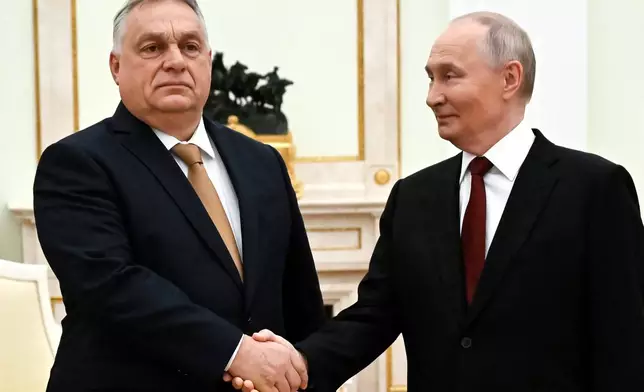 FILE - Russian President Vladimir Putin, right, and Hungarian Prime Minister Viktor Orban shake hands during their meeting at the Senate Palace of the Kremlin in Moscow, Russia, Nov. 28, 2025. (Alexander Nemenov/Pool Photo via AP, File)