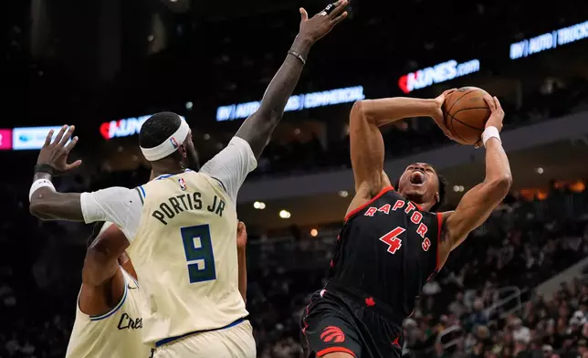 Toronto Raptors' Scottie Barnes (4) shoots against Milwaukee Bucks' Bobby Portis (9) during the first half of an NBA basketball game, Thursday, Dec. 18, 2025, in Milwaukee. (AP Photo/Aaron Gash)
