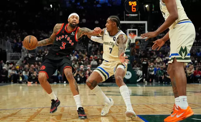 Toronto Raptors' Brandon Ingram (3) drives to the basket against Milwaukee Bucks' Kevin Porter Jr. during the first half of an NBA basketball game, Thursday, Dec. 18, 2025, in Milwaukee. (AP Photo/Aaron Gash)