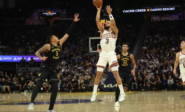 Phoenix Suns forward Dillon Brooks (3) shoots against Golden State Warriors guard Will Richard (3) during the first half of an NBA basketball game in San Francisco, Saturday, Dec. 20, 2025. (AP Photo/Jed Jacobsohn)