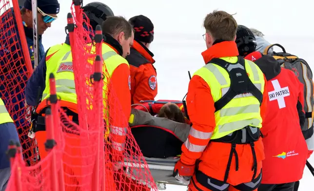 Michelle Gisin of Switzerland is being carried on a stretcher after a fall during an alpine ski, women's World Cup downhill training, in St. Moritz, Switzerland, Thursday, Dec. 11, 2025. (Keystone Via AP)
