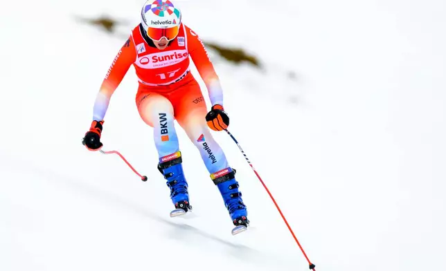 Michelle Gisin of Switzerland in action before a fall during the women's Downhill training race at the Alpine Skiing FIS Ski World Cup, in St. Moritz, Switzerland, Thursday, Dec. 11, 2025. (Jean-Christophe Bott/Keystone via AP)
