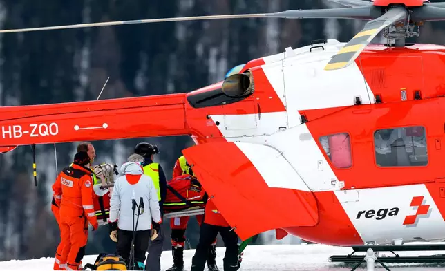 Michelle Gisin of Switzerland is being carried on a stretcher after a fall during an alpine ski, women's World Cup downhill training, in St. Moritz, Switzerland, Thursday, Dec. 11, 2025. (Keystone Via AP)