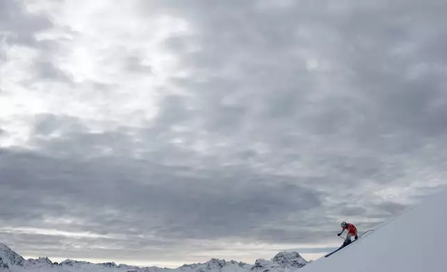 Switzerland's Michelle Gisin speeds down the course during an alpine ski, women's World Cup downhill training, in St. Moritz, Switzerland, Thursday, Dec. 11, 2025. (AP Photo/Gabriele Facciotti)