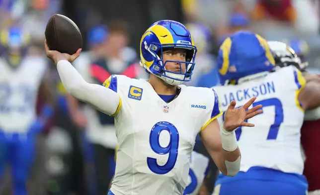 Los Angeles Rams quarterback Matthew Stafford looks to pass the ball in the second half of an NFL football game against the Arizona Cardinals, Sunday, Dec. 7, 2025, in Glendale, Ariz. (AP Photo/Ross D. Franklin)