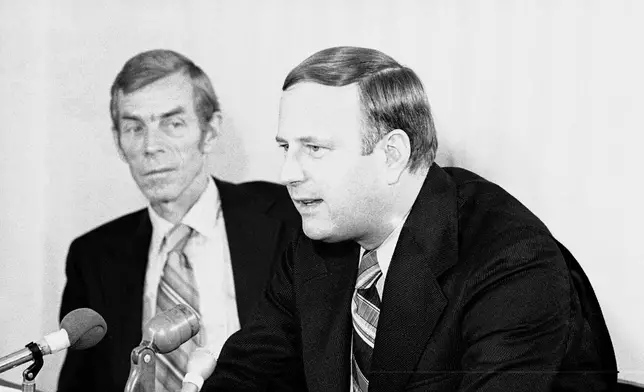 FILE - Chuck Neinas, right, speaks after being named commissioner of the Big Eight conference as professor Charles H. Oldfather looks on, Oct. 6, 1971, Kansas City, Kan. (AP Photo/William P. Straeter, File)