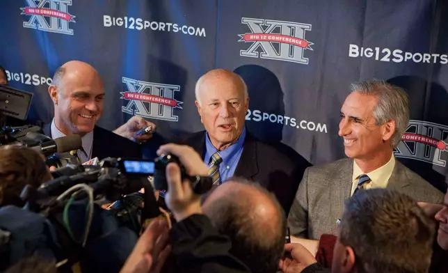 FILE - West Virginia President James Clements, left, Big 12 Interim Commissioner Chuck Neinas, center, and West Virginia Athletic Director Oliver Luck discuss the school's entrance to the Big 12 Conference during a news conference, Nov. 1, 2011, in Morgantown, W.Va. (AP Photo/David Smith, File)